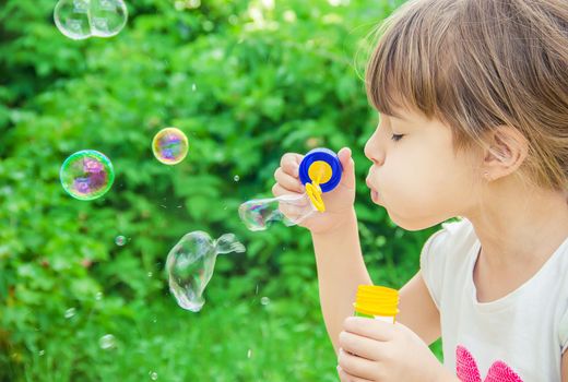 The children are blowing bubbles. Selective focus.