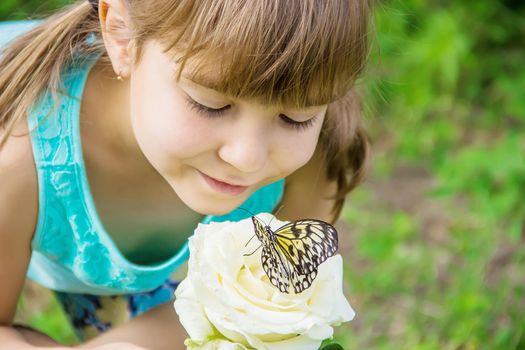 Child with a butterfly. Idea leuconoe. Selective focus.