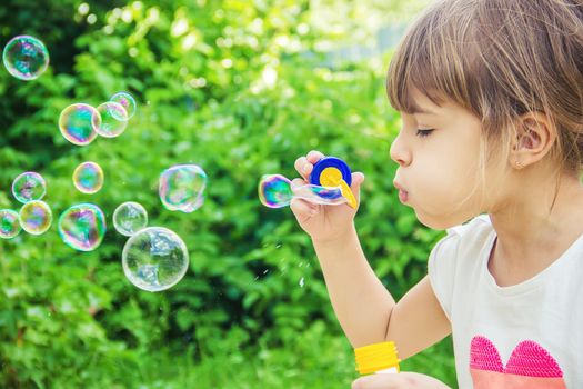 The children are blowing bubbles. Selective focus.