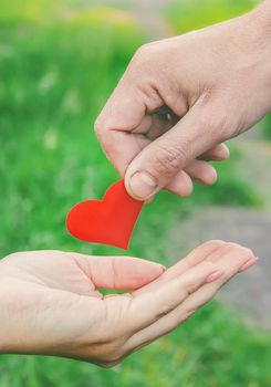 child and father have a heart in their hands. Selective focus. nature.