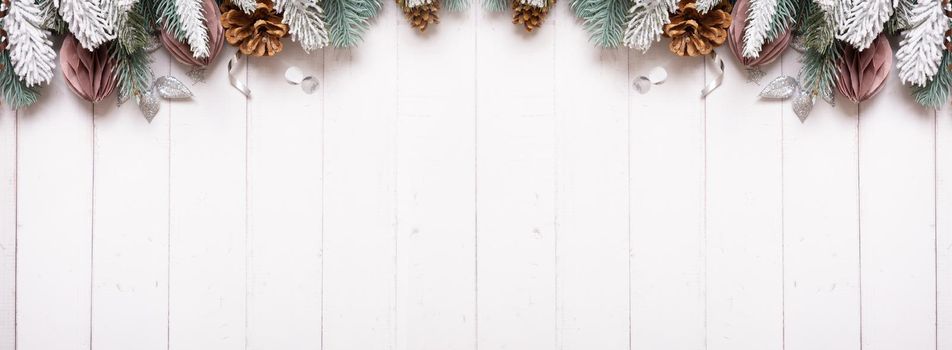 Christmas banner flat lay composition from pine, cones, balls on wooden background top view. Copy space.