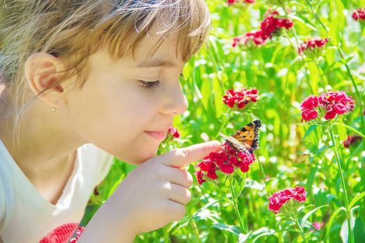 Child with a butterfly. Idea leuconoe. Selective focus.