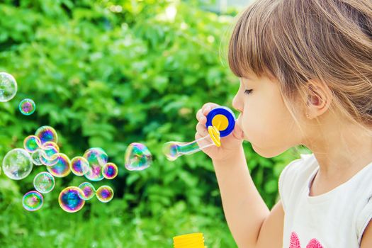 The children are blowing bubbles. Selective focus.