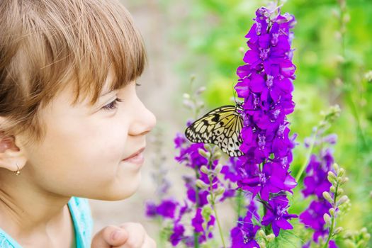 Child with a butterfly. Idea leuconoe. Selective focus.