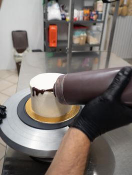 decorating a frosted cake with chocolate and nutella