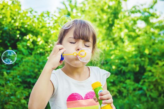 The children are blowing bubbles. Selective focus.