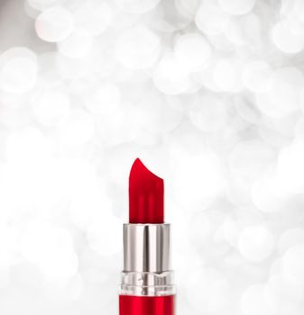 Cosmetic branding, sale and glamour concept - Red lipstick on silver Christmas, New Years and Valentines Day holiday glitter background, make-up and cosmetics product for luxury beauty brand