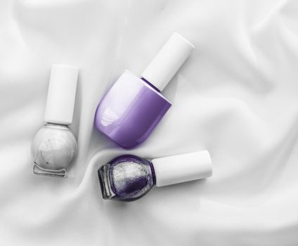 Cosmetic branding, salon and glamour concept - Nail polish bottles on silk background, french manicure products and nailpolish make-up cosmetics for luxury beauty brand and holiday flatlay art design