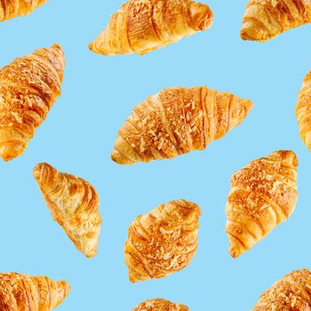 seamless pattern made from Fresh croissant isolated on blue background. Bakery pattern with baked croissant with cheese.