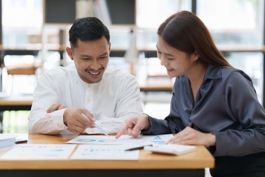 Two asian fund manager brainstorming new business project finance investment concept.