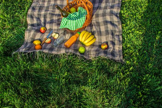 Plaid for a picnic on the grass. Selective focus.