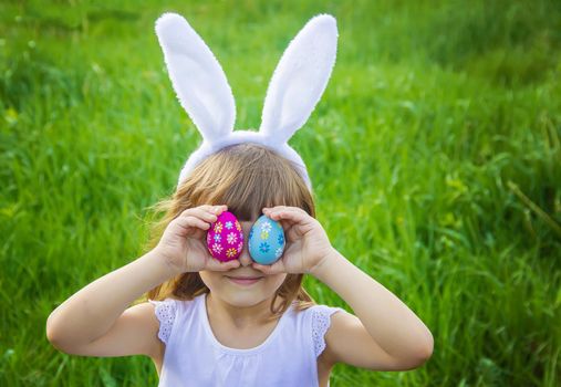 Child with rabbit ears. Easter. Selective focus.