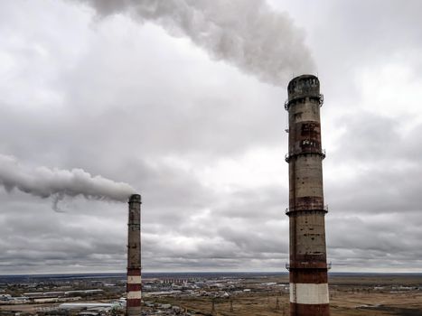 Atmospheric pollution,harmful emissions and global warming,ecological problem.Smoky chimneys of the power plant aerial view.Electric power generation,power plant for burning coal.Thick smoke from fuel