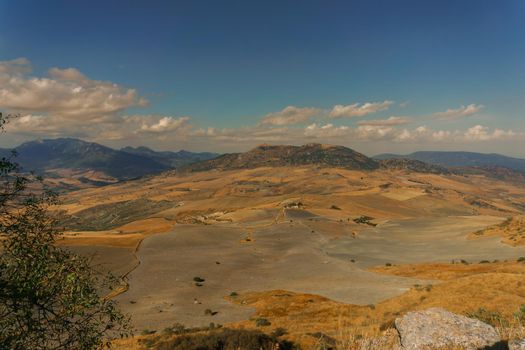 agricultural mountain landscape at the back of in the ruins of Acinipo in Ronda, . with cloudy sky