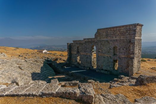 rear view of the Roman theater of Acinipo in Ronda, Malaga with the amphitheater in the foreground.