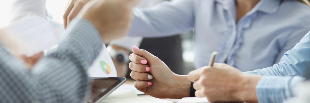 Close-up of coworkers discussing working moments and checking financial report in conference room. Business meeting and paper mess. Business, plan concept