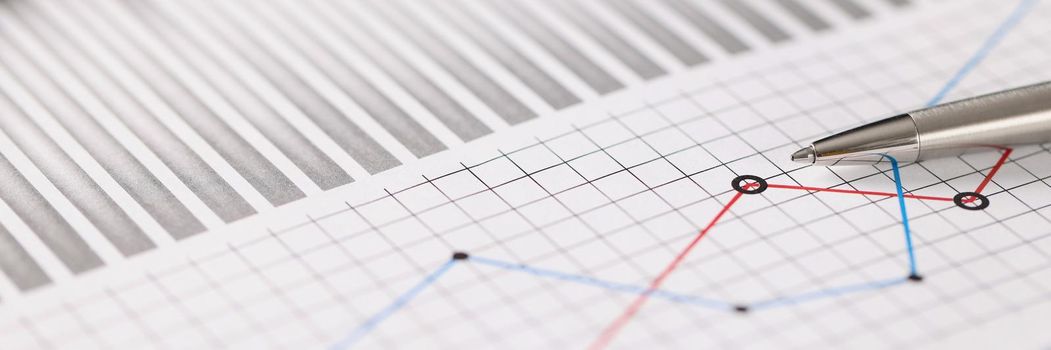 Close-up of business document with some graphic on it, blue and red lines in increase and decrease order. Statistics, business, economy, finance concept