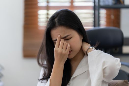 Portrait of stressed asian businesswoman in the office. burnout syndrome or deadline project concept.