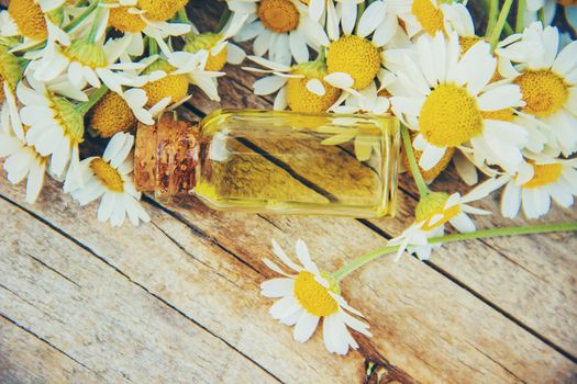 Chamomile extract in a small bottle. Selective focus.