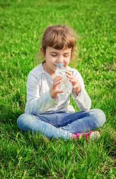 Baby drinks water from bottle. selective focus.