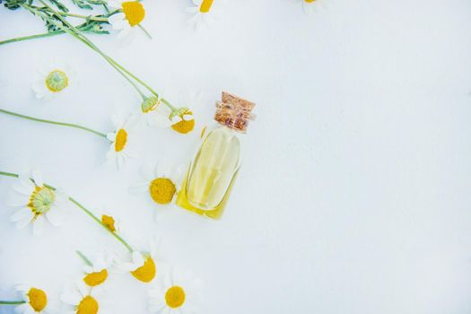 Chamomile extract in a small bottle. Selective focus nature.