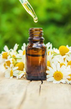 Chamomile extract in a small bottle. Selective focus.