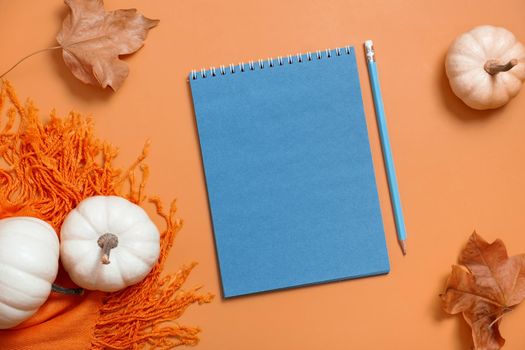 Blank notebook for text and pumpkins with autumn leaves. Autumn theme mock up.