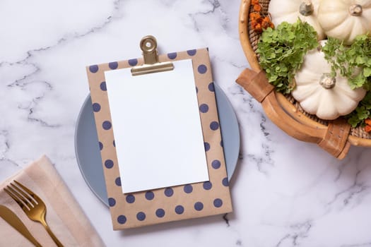 Autumn flat lay with blank tablet and decorative pumpkins on marble background top view.