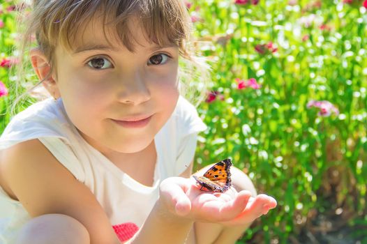 Child with a butterfly. Idea leuconoe. Selective focus.