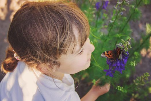 Child with a butterfly. Idea leuconoe. Selective focus.