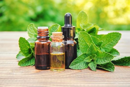 The mint extract in a small jar. Selective focus.