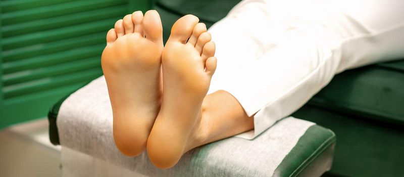 Feet of a young caucasian woman while treatment procedure in a beauty salon