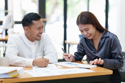 Two asian fund manager brainstorming new business project finance investment concept.