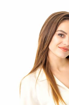 Portrait of a beautiful young caucasian smiling brunette woman with long straight hair standing and looking at the camera on white background