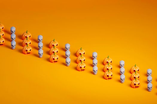 3d render of three rows of many Halloween pumpkin and skulls on orange background