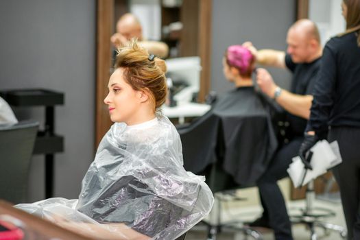 Beautiful young blonde caucasian woman in the modern hair salon