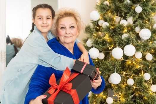 Cute little girl granddaughter family celebrating Christmas New Years Eve at home. Winter holiday concept.