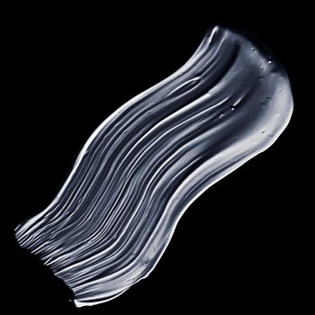 Beauty smear, cosmetics product and abstract liquid concept - Silver paint brush stroke texture isolated on black background, glamour make-up sample smudge