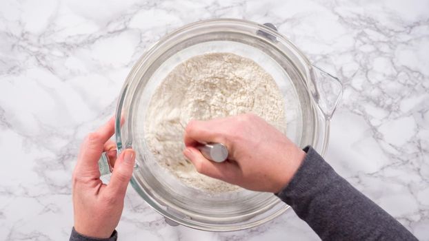 Flat lay. Step by step. Mixing ingredients in kitchen mixer to bake homemade brioche buns.