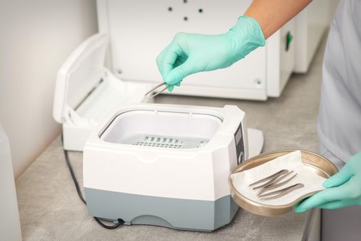 Hand disinfects tweezers with cleaning systems for medical instruments. Ultrasonic cleaner