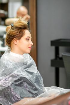 Beautiful young blonde caucasian woman in the modern hair salon