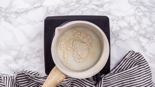 Flat lay. Step by step. Preparing tangzhong in a small saucepan to bake homemade bread.