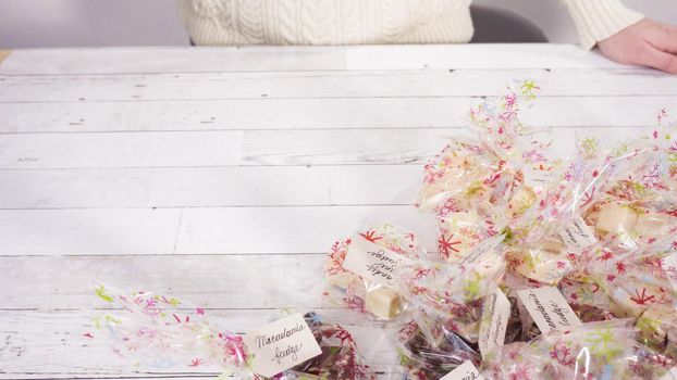 Step by step. Packaging homemade candy cane fudge into small gift bags.