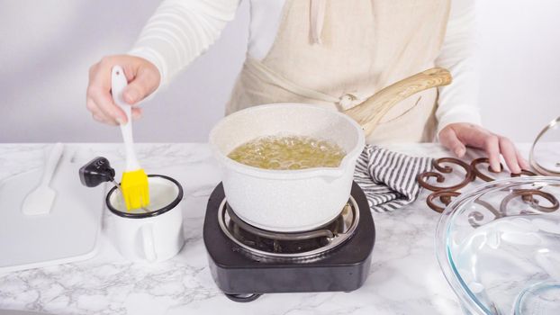 Step by step. Caramelizing sugar in a small cooking pot over the small electric stove.