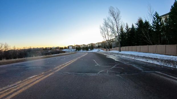 Driving on typical paved roads in a suburban upscale residential neighborhood of America.
