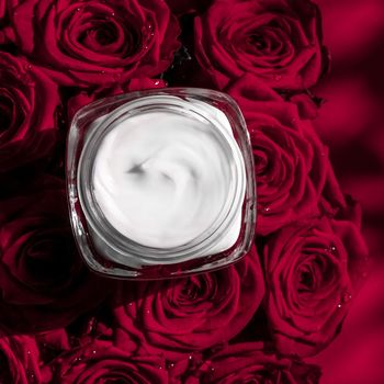 Luxe cosmetics, branding and anti-age concept - Face cream skin moisturizer and red roses flowers, luxury skincare cosmetic product on floral background as beauty brand holiday flatlay design