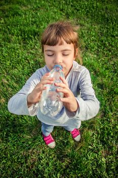 Baby drinks water from bottle. selective focus.