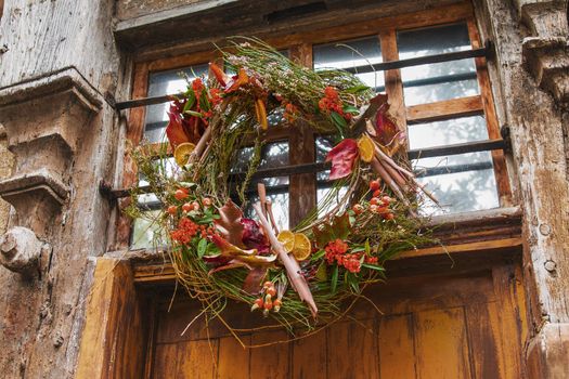 Wreath autumn or winter decoration on the shabby door