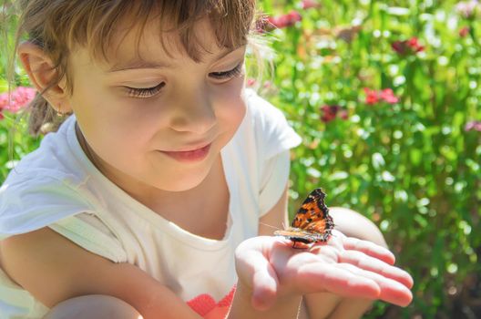 Child with a butterfly. Idea leuconoe. Selective focus.