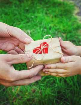 gift in the hands of a child. congratulations on his father's day.